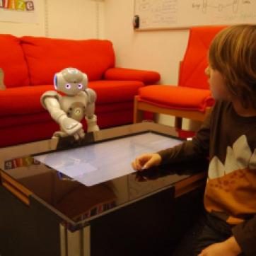 The ALIZ-E project studied how social robots could support children during a stay in hospital: education happened through a large touch screen.